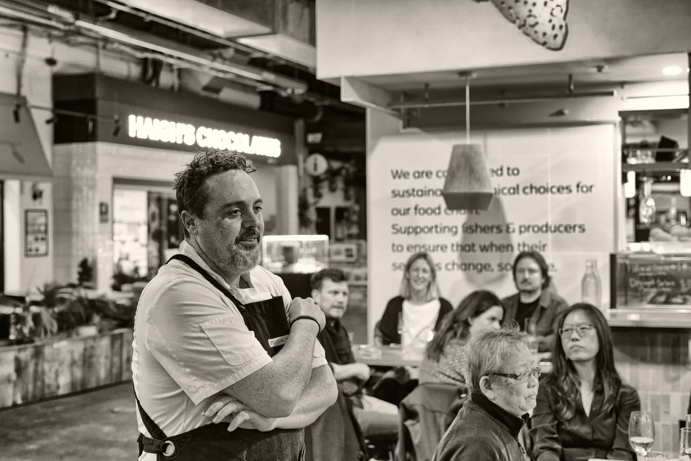 Chef Jamie Steele photographed in monochrome at the Fair Seafood After Dark dinner, Adelaide Central Market