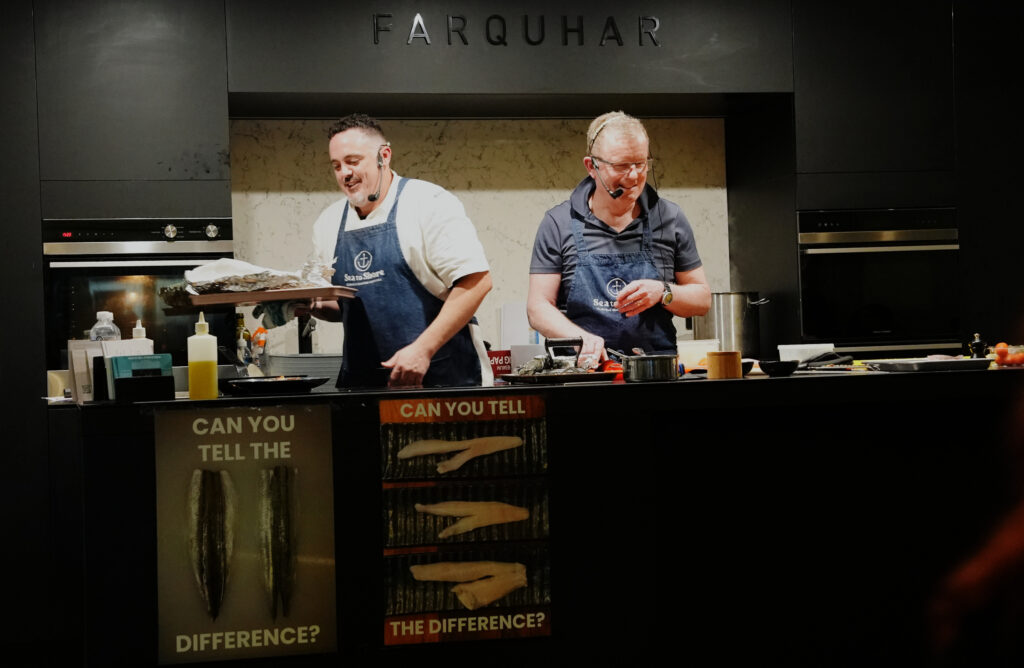 Geoff Staples and chef Jamie Steele demonstrating seafood cookery to an audience at the Sea to Shore masterclass in Glenelg, South Australia